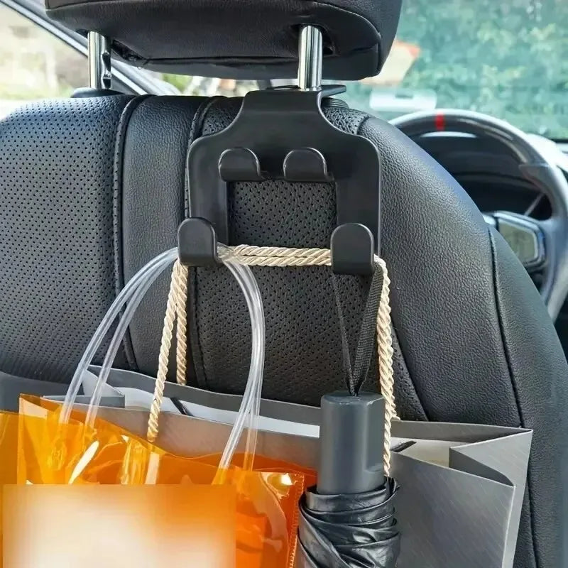 A black car back seat phone holder and organizer hook with a rope and clear plastic bag attached.
