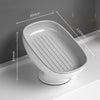 A white suction cup soap holder with a drainage tray shown in profile view.