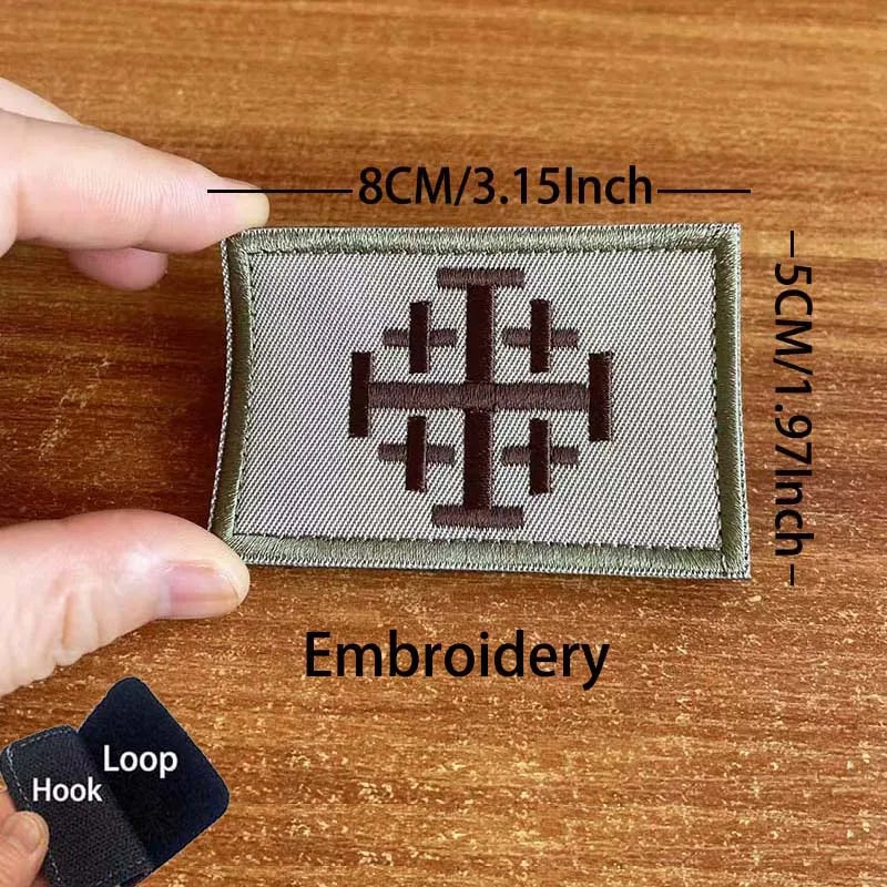 A square embroidered tactical patch featuring a Templar cross design on a green fabric background.