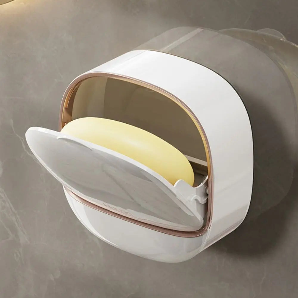 A white wall mounted waterproof soap dish with a drainage feature is shown open, revealing a yellow bar of soap.