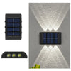 A solar powered outdoor wall light with upward and downward illumination mounted on a gray textured surface.