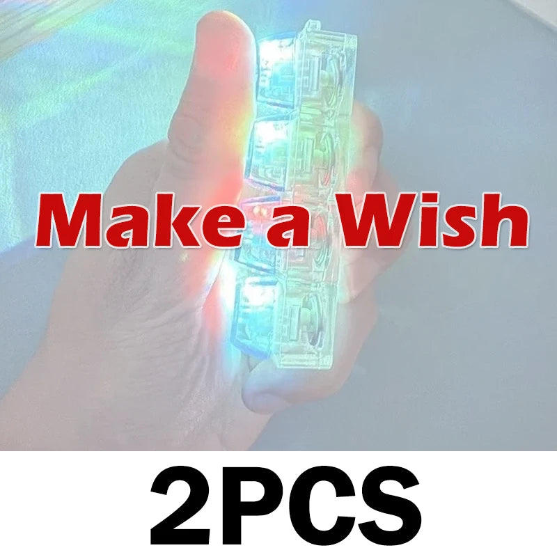 A hand holds a clear, light-up keyboard keychain fidget toy with glowing blue lights.