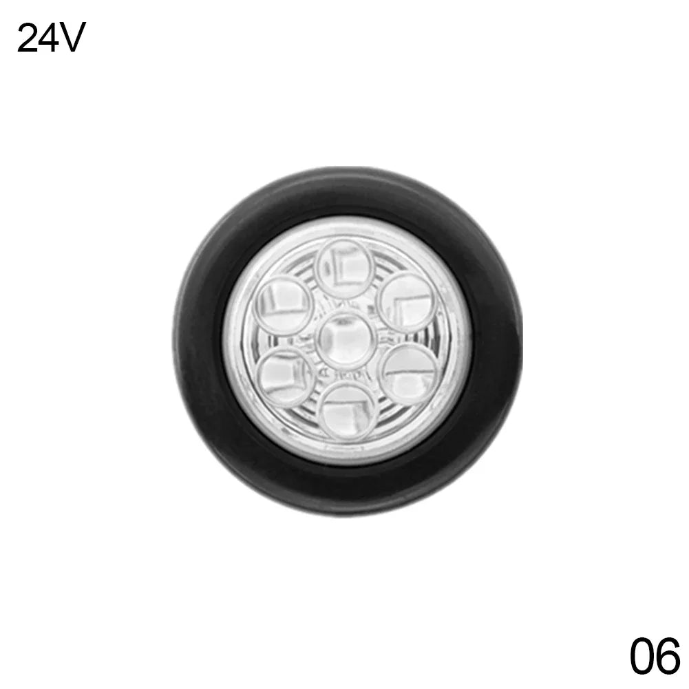 A round flush mount tail light with six clear lenses and a black housing.