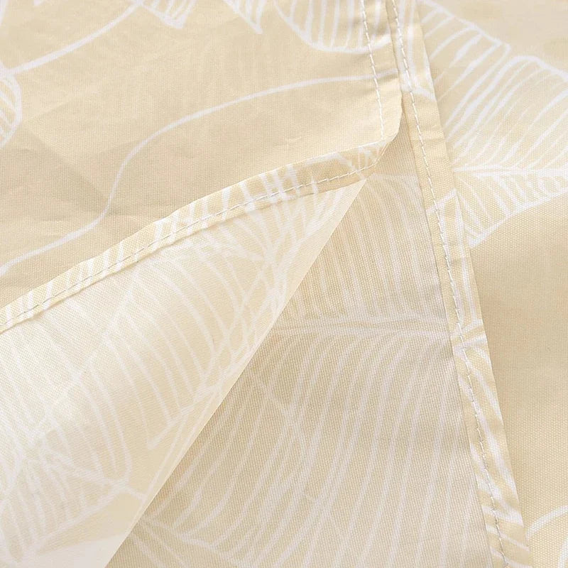 A close-up of a cream-colored shower curtain fabric with a subtle white striped pattern and a gathered edge.