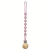A pink silicone pacifier clip with a teether attached.