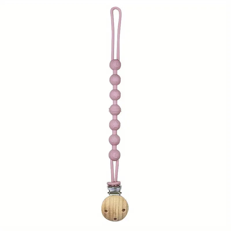 A pink silicone pacifier clip with a teether attached.