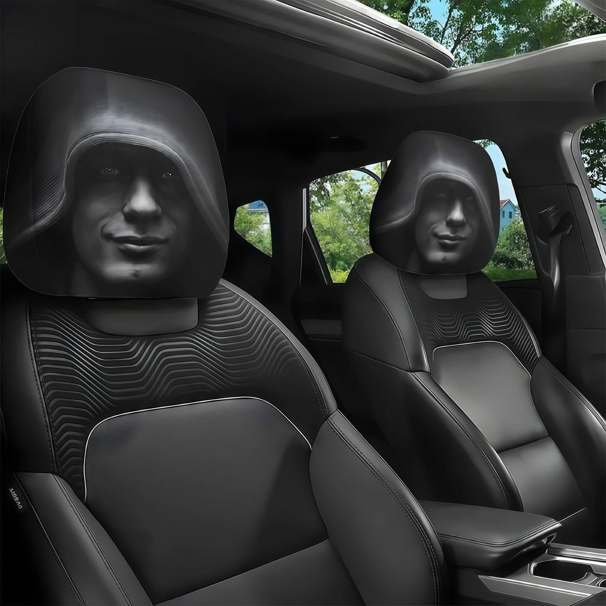 Two black car headrest covers with sculpted hoods are shown inside a vehicle cabin.