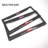 A pair of black racing style license plate frames with red and white decals for a JDM aesthetic.