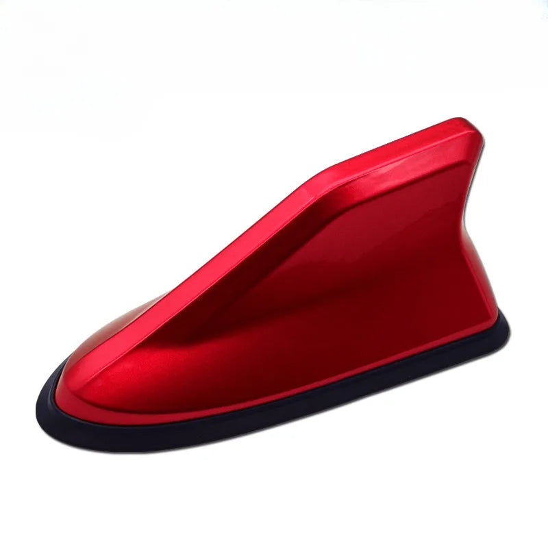 A red aerodynamic shark fin car antenna with a signal amplifier.