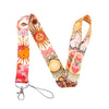 A colorful lanyard featuring celestial sun and moon designs on a fabric strap with a metal clip.