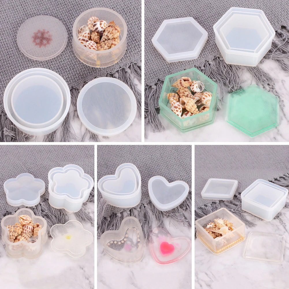 A collection of silicone jewelry boxes and resin molds in various shapes and colors, including hexagonal, round, and heart-sh