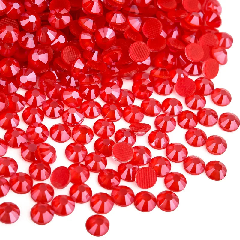 A pile of bright red faceted rhinestones and round sequins for DIY crafts and clothing decoration