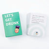 A green card game box titled Let's Get Drunk featuring a illustration of a person in a purple hat.