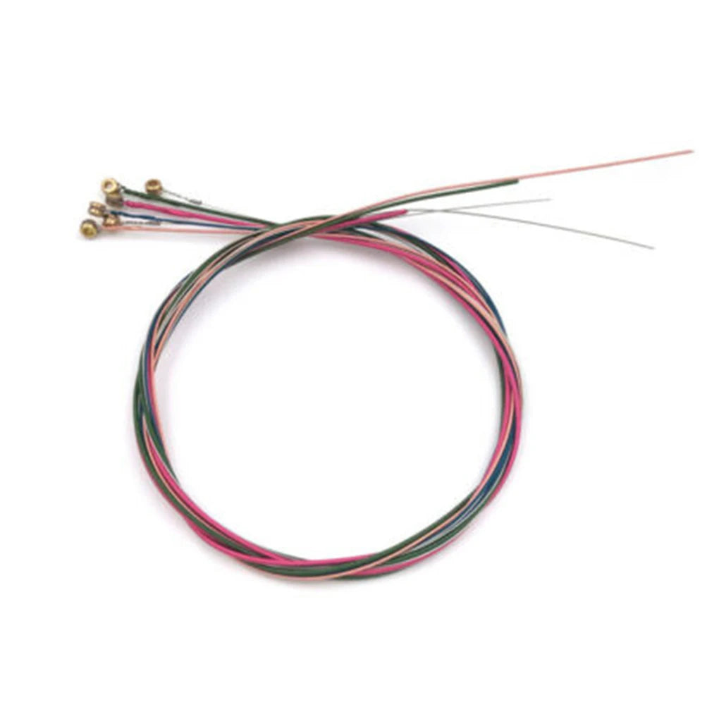 Set of six color-coded rainbow acoustic guitar strings coiled together