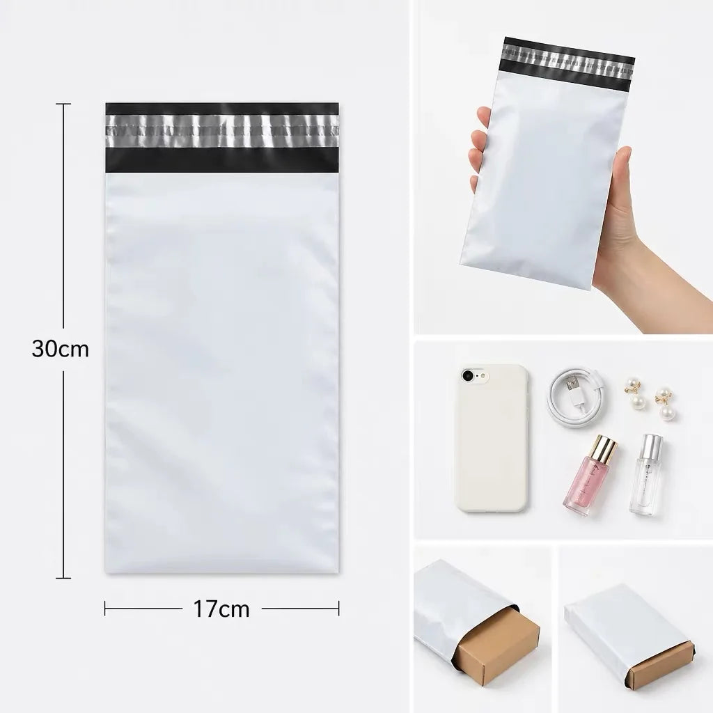 A white self-sealing mailing bag with a black header, shown next to a ruler for scale.
