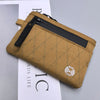 A tan RFID-blocking travel wallet with a black zipper and carabiner clip shown against a white background.