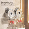 Wall-mounted suction cup storage basket holding stacked silver discs with a water ripple design