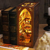 A wooden book nook kit featuring an arched display with internal LED lighting and detailed miniature books.