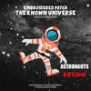 Embroidered patch featuring an astronaut figure in orange and white, set against a dark starry background.