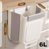A white foldable hanging trash can with a gray lid and ribbed body is shown mounted on a cabinet shelf.