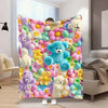 A colorful flannel throw blanket featuring pastel floral patterns and teddy bear motifs displayed on a bed.