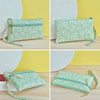 A set of light green PU leather wristlet wallets with a white daisy print and gold hardware shown from multiple angles.