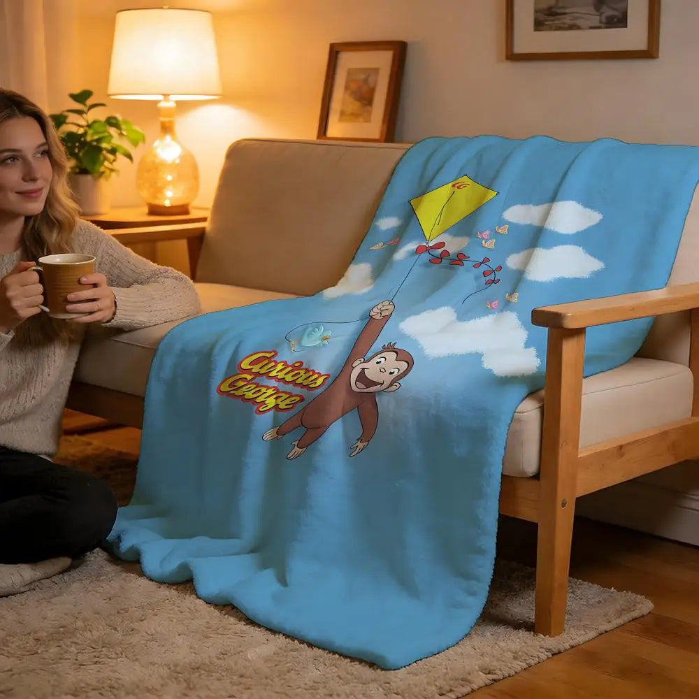 A light blue throw blanket featuring a cartoon character holding a yellow kite against a white cloudy background.
