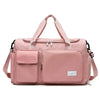A pink large capacity travel duffel bag with a separate shoe compartment and shoulder straps.