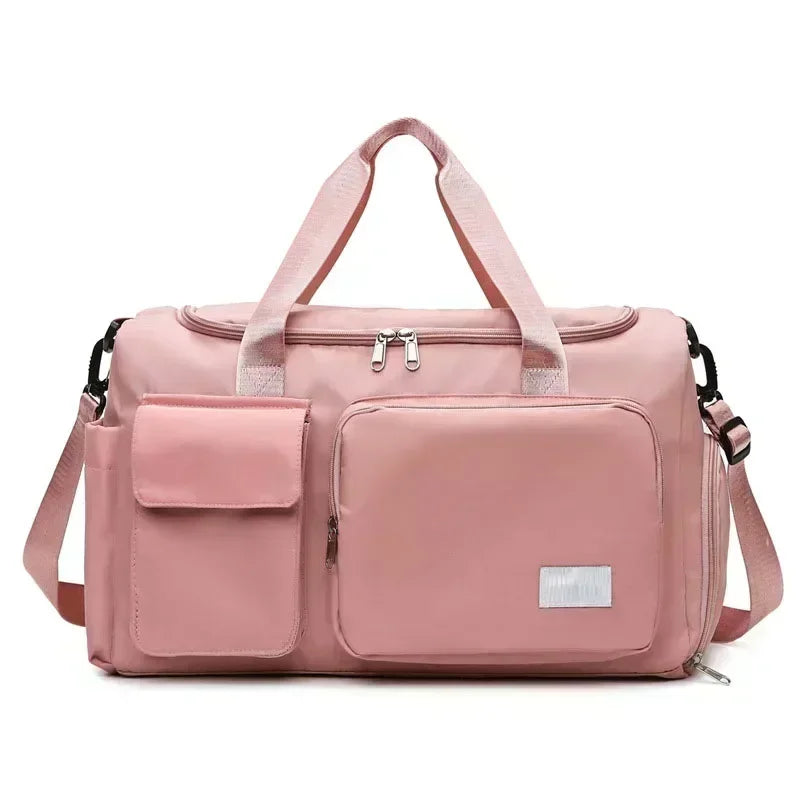 A pink large capacity travel duffel bag with a separate shoe compartment and shoulder straps.