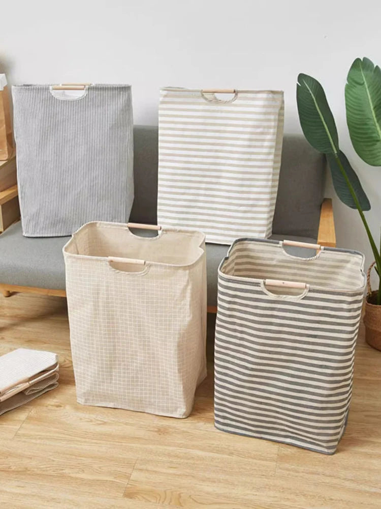 Three fabric laundry baskets in striped and checkered patterns are displayed on a wooden floor.