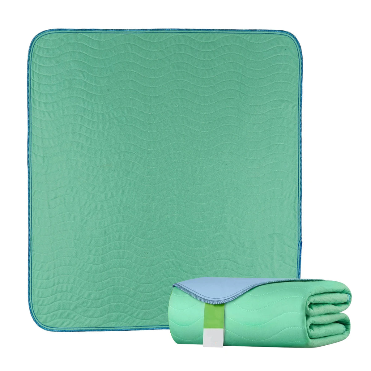 A teal reusable waterproof underpad and a rolled green towel for bed protection.