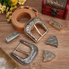 A set of vintage Western belt buckles in antique gold and silver, including a leather strap and various metal buckles.