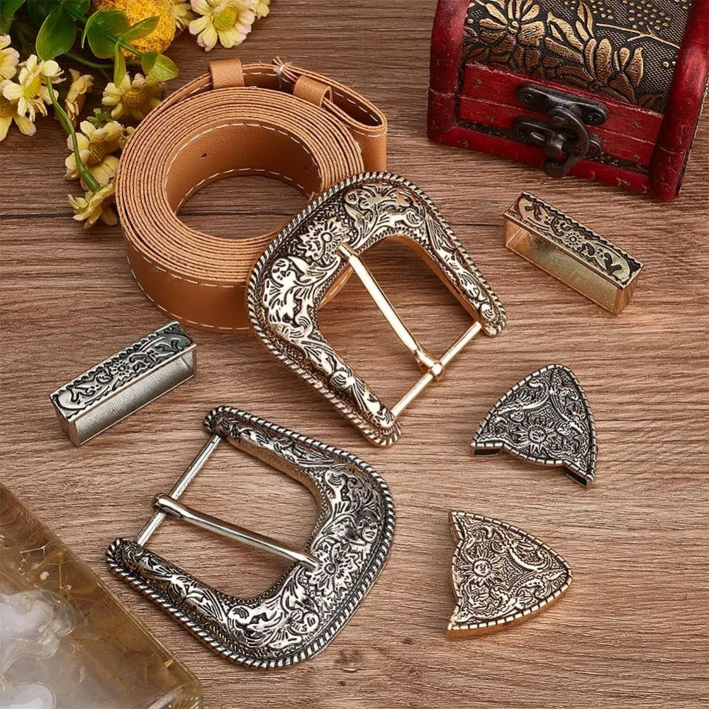 A set of vintage Western belt buckles in antique gold and silver, including a leather strap and various metal buckles.
