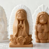 A terracotta silicone mold of a praying girl figure used for candles, soap, and craft decor.