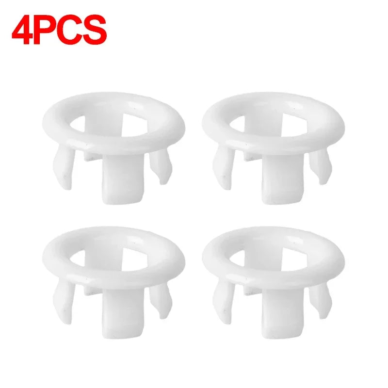 A set of four white chrome-plated sink overflow covers or stoppers.
