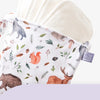 A white waterproof wet dry bag for baby is shown, featuring a pattern of woodland animals and greenery.
