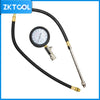 Engine cylinder compression tester kit featuring a black hose, gauge, and multiple adapters.