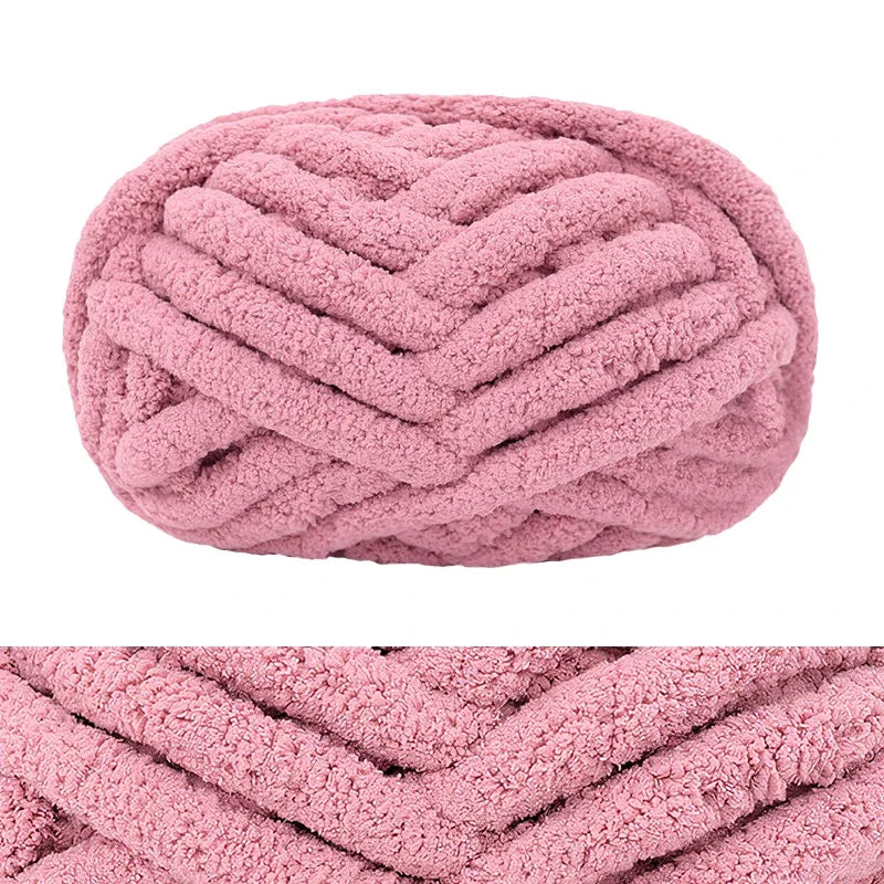 A ball of pink chunky chenille yarn used for hand knitting and crochet