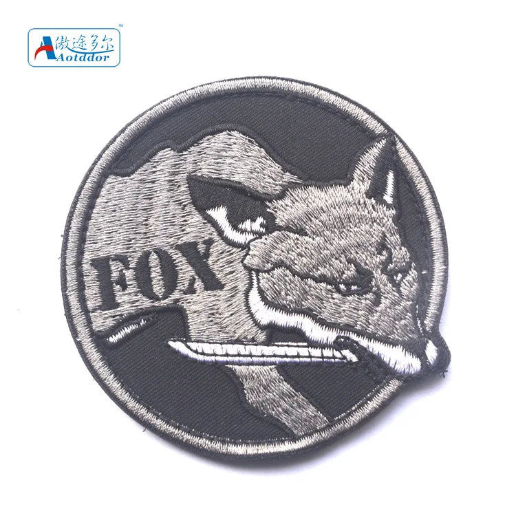 Embroidered patch featuring a fox head design with hook and loop backing.