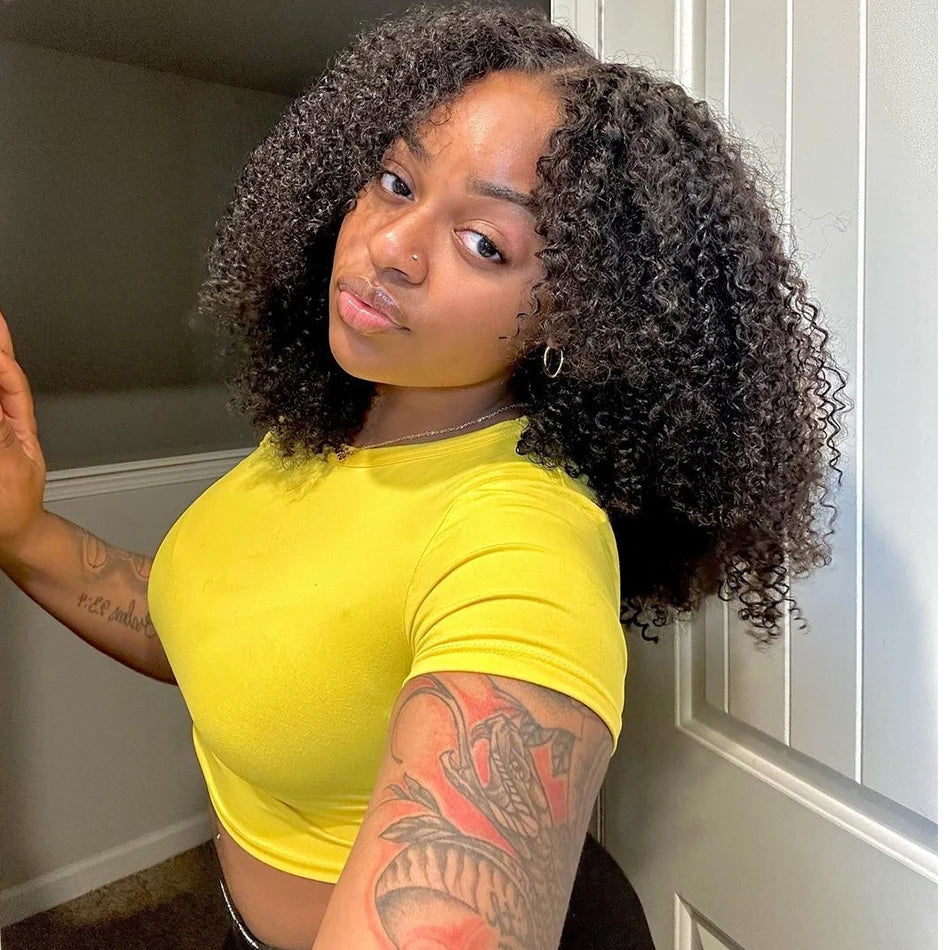A woman wearing a yellow top and displaying a tattoo on her arm.