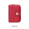 A vintage RFID blocking short wallet in wine red leather with a zipper closure.