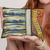 A canvas cosmetic bag featuring a vintage sardine print design on the front.