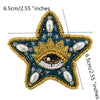 A gold and teal star-shaped patch decorated with white pearls and sparkling rhinestones.