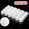 A collection of white heart-shaped flameless LED candles arranged on a dark surface.