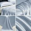 Close-up view of smooth, flowing light blue ice silk cooling bed sheets draped and folded.