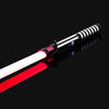 A close-up view of an RGB metal lightsaber with a red blade and black hilt against a dark background.