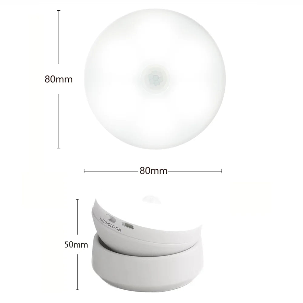 A white, round LED night light with a flat, curved base and an auto-off-on feature.