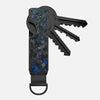 A minimalist aluminum key organizer with a black and blue marbled grip and a set of keys attached.