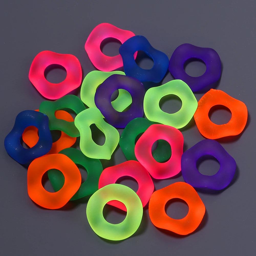 A collection of colorful acrylic spacer beads in various shades including pink, purple, blue, green, and orange.