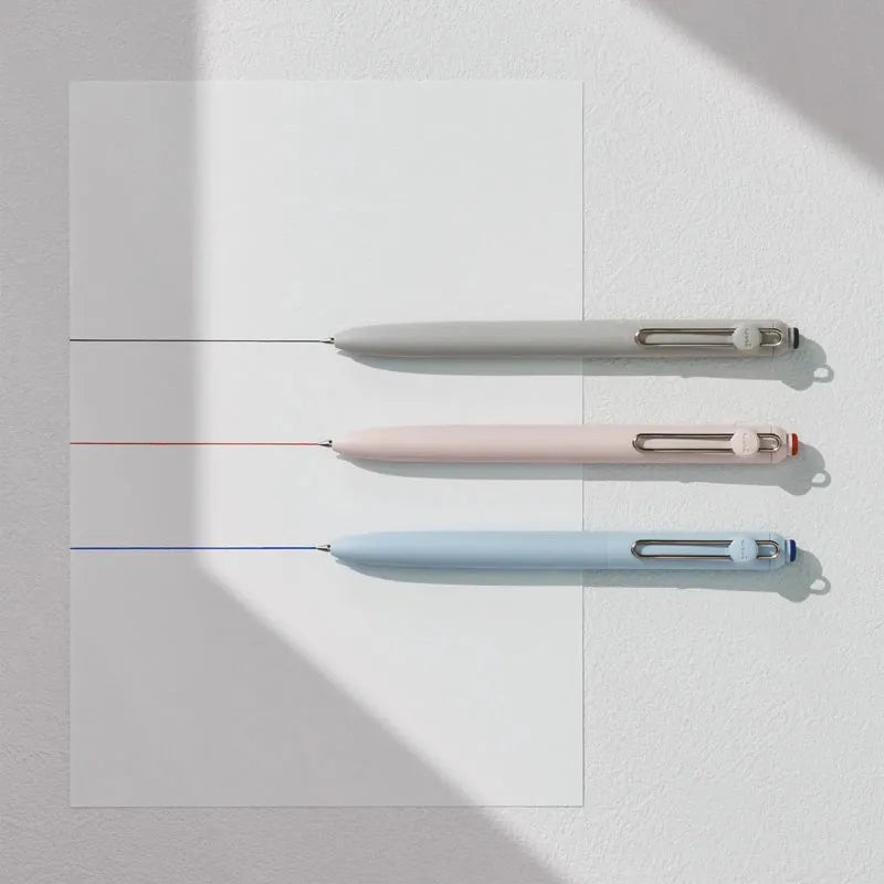 Three gel pens in white, pink, and light blue are displayed against a white background.